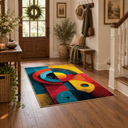 Colorful vintage geometric cubist face area rug styled in a welcoming entryway