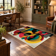Colorful vintage geometric retro floral area rug angled view in a classic bedroom