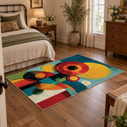 Colorful vintage geometric geometric flowers area rug displayed beside a cozy bed