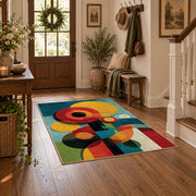 Colorful vintage geometric geometric flowers area rug styled in a welcoming entryway