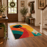 Colorful vintage geometric tree landscape area rug styled in a welcoming entryway