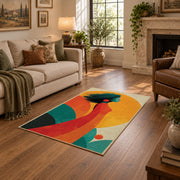 Colorful vintage geometric tree landscape area rug shown beside a comfortable sofa