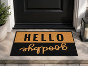 Suupia Hello Goodbye doormat in black and golden tan at an entryway